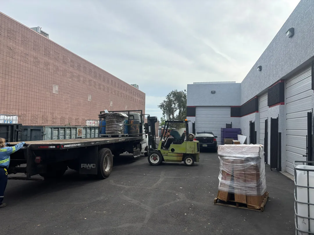 Forklift and flatbed truck at the Scrap Metal Exchange yard in Tempe