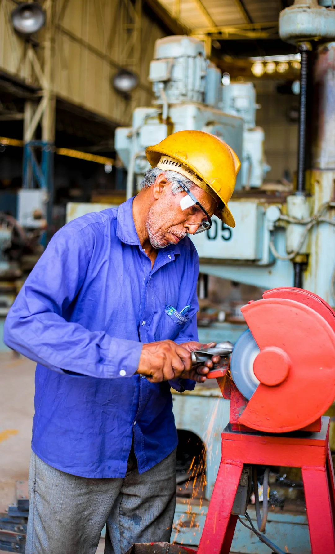 Scrap yard worker in hard hat and safety glasses